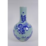 A Chinese celadon ground porcelain bottle vase with raised blue and white kylin decoration, 35cm