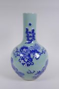 A Chinese celadon ground porcelain bottle vase with raised blue and white kylin decoration, 35cm