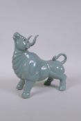 A Chinese celadon glazed porcelain figure of a buffalo, AF repair, 22cm long