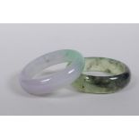 A bi-colour jade bangle, and another, 7cm diameter