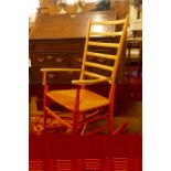 A beech wood ladder back rocking chair with rush seat