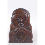 A vintage carved wood figural automaton clock with moving eyes, 18cm high