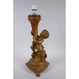 A gilt mounted putti and dolphin table lamp, 44cm high