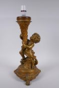 A gilt mounted putti and dolphin table lamp, 44cm high