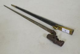 A British Army 1876 pattern socket bayonet in a leather scabbard with brass mounts, stamped WDE7