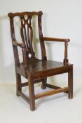 A C19th elm open armchair with later carving