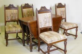A c19th oak gateleg table with barley twist supports, and four oak dining chairs with carved and