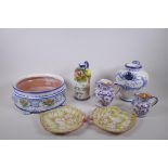 A collection of Italian Majolica to include a vinegar bottle, bramble wine jug,