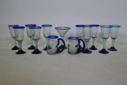 A quantity of hand blown drinking glasses, 19cm high