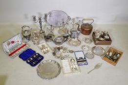 A large quantity of silver plate to include an Elkington teapot, candelabras, flatware, spirit