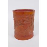 A Chinese bamboo brush pot with carved decoration of Lo-han in a landscape, 16cm high