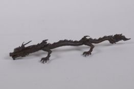An oriental bronze figure of a five toed dragon, indistinct mark to base, 15cm long