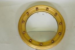 A C19th Regency style giltwood circular wall mirror with convex glass, 50cm diameter