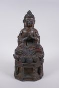 A Chinese bronze figure of Buddha seated on a throne with the remnants of gilt patina, character
