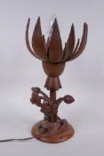 A carved wood lotus flower table lamp, the petals opening to reveal the bulb, 35cm high