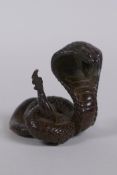 A Japanese style bronze okimono cobra, mark to base, 4cm high