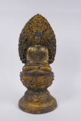 A Sino Tibetan gilt metal figure of Buddha seated on a lotus flower, 37cm high