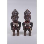 A pair of African Yoruba tribe carved wood Ere Ibeji figures, 28cm high