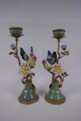 A pair of polychrome porcelain and gilt metal candlesticks decorated with birds and flowers, 32cm