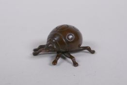 A Japanese style bronze okimono ladybird, 3cm