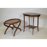 A Victorian mahogany two tier occasional table with oval top, raised on sabre supports, 70 x 43 x
