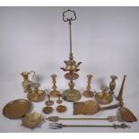 A quantity of brassware including a four spout whale oil lamp, pairs of candlesticks, ash trays,