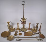 A quantity of brassware including a four spout whale oil lamp, pairs of candlesticks, ash trays,