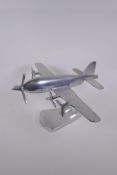 A decorative polished aluminium model of a plane with five propellers, 43cm wingspan