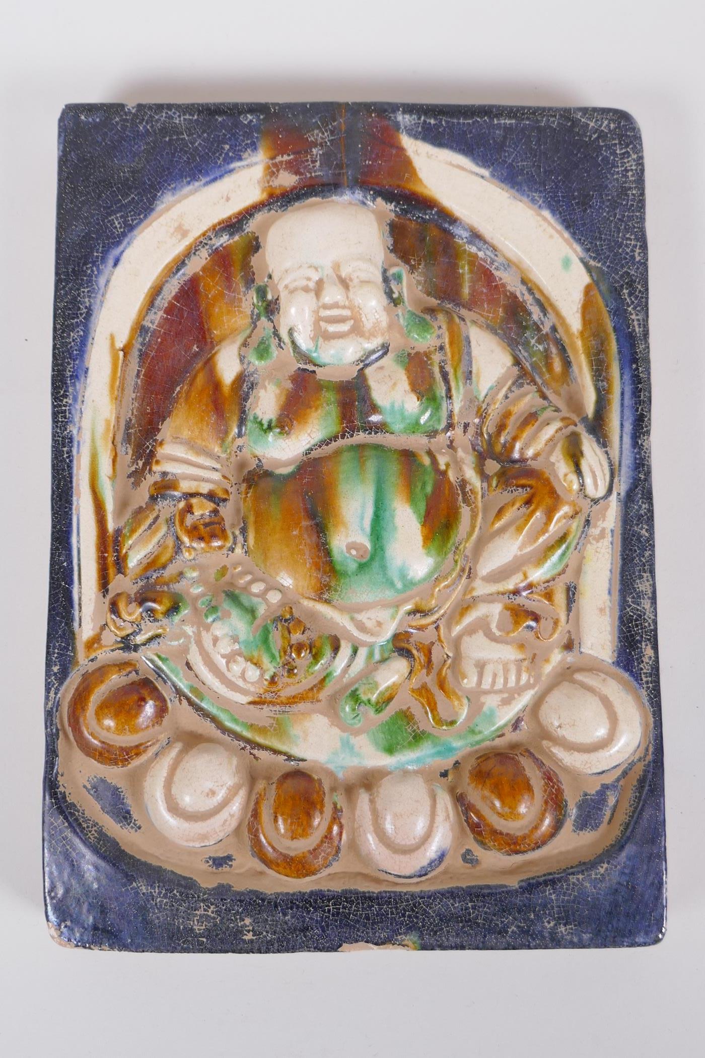 A Chinese Sancai glazed porcelain tile with raised Buddha decoration, 18 x 25cm