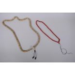 A string of bone mala beads, and a string of coral mala beads, longest 108cm