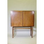 A mid century Danish side cabinet, designed by Ole Wanscher for Poul Jeppesen, labelled verso,