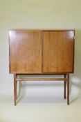 A mid century Danish side cabinet, designed by Ole Wanscher for Poul Jeppesen, labelled verso,