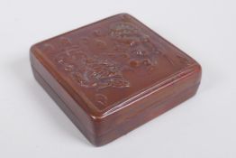 A Chinese copper box with repousse dragon and phoenix decoration, 8 x 8cm