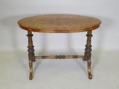 A C19th inlaid walnut stretcher table, with an oval top and turned supports, 91 x 51cm, 64cm high