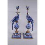 A pair of blue and white porcelain and gilt metal parrot candlesticks, 48cm high