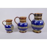 A set of three Queen Victoria Diamond Jubliee Doulton Lambeth graduated stoneware jugs, all three