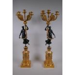 A pair of bronze and ormolu four branch candelabra in the form of classical women, 71cm high