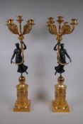 A pair of bronze and ormolu four branch candelabra in the form of classical women, 71cm high
