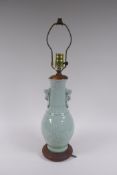 A Chinese celadon glazed porcelain vase with underglaze kylin decoration, converted to a lamp,