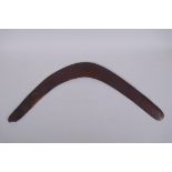 An antique Australian wood boomerang, 59cm tip to tip