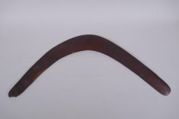 An antique Australian wood boomerang, 59cm tip to tip