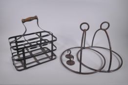An antique riveted metal six bottle carrier, together with two metal hanging pan holders, carrier 31