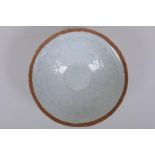 A Chinese Song style celadon glazed porcelain dish of conical form, with underglaze decoration of