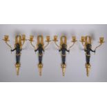 Two pairs of ormolu and bronze two branch candle sconces in the form of winged putti, 34cm high