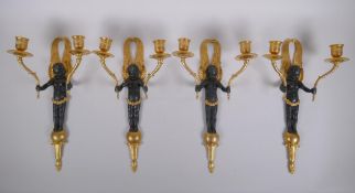 Two pairs of ormolu and bronze two branch candle sconces in the form of winged putti, 34cm high