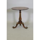 A Regency rosewood wine table, with parcel gilt decoration, raised on a carved and fluted column and