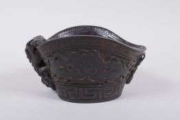 A Chinese horn libation cup with carved kylin decoration, mark to base, 14 x 12cm, 8cm high