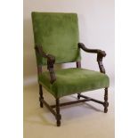 A C19th high back open arm chair with carved lion mask arms, raised on turned supports, AF