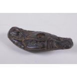 An antique Syrian carved hardstone figural oil lamp, 12cm long