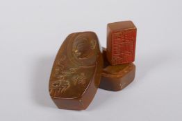 A Chinese soapstone box and cover opening to reveal a seal, the cover with carved Buddha decoration,